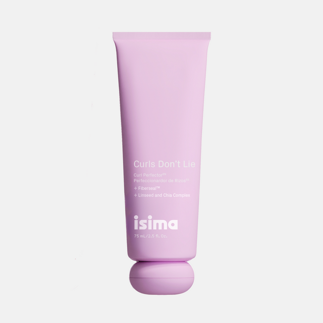 A pink tube labeled “Curls Don’t Lie Curl Perfector” by Isima, featuring a circular matching cap and white text detailing ingredients and hydration benefits for curly hair. This 75 mL (2.5 fl. oz.) light-hold styling cream is specially designed to define and nourish your curls.