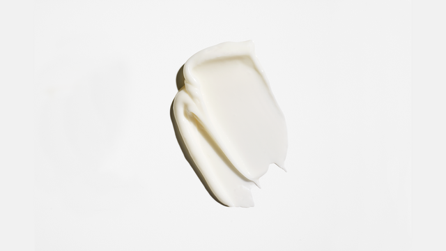 Suavísima Hydrating Conditioner: a smooth, creamy, off-white lotion spread thickly on a plain white background—designed to soften hair and enhance shine.