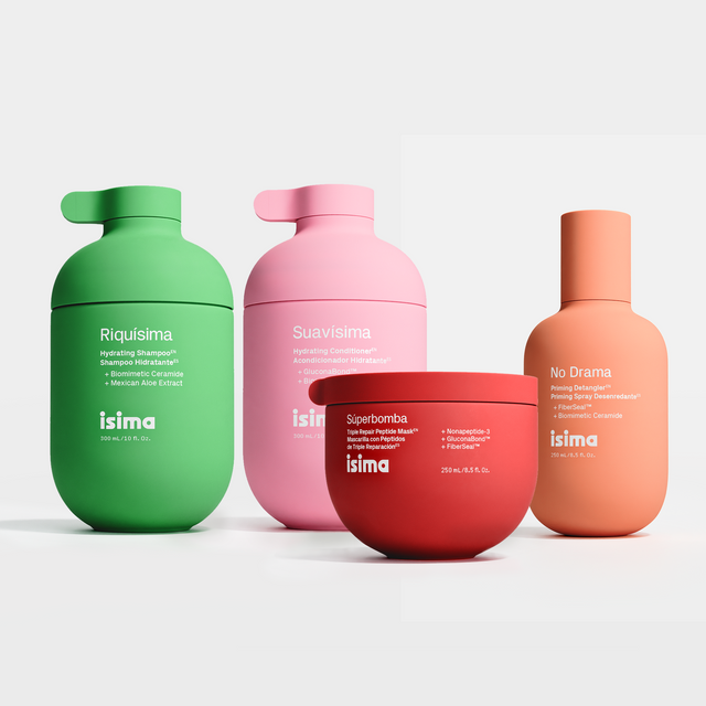 Shakira's Wash Day Ritual by isima ($134 value) features four colorful hair care products for waves and curls: green, pink, and orange hydrating shampoo bottles plus a red jar, each labeled in Spanish.
